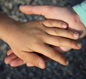Guiding-Hands Woman's hand holding child's hand
