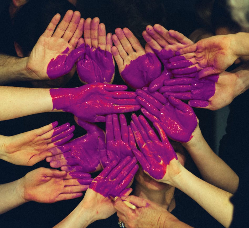 Hands together with heart painted on them